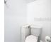 Bright, clean bathroom features a standard toilet, modern toilet paper holder, and small storage unit at 942 Jackson Ave, Davenport, FL 33837
