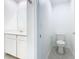 Bathroom featuring tile floors, single sink vanity, and a toilet at 942 Jackson Ave, Davenport, FL 33837