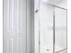 Clean bathroom showcasing a modern glass shower, and a closet at 942 Jackson Ave, Davenport, FL 33837