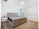 Well-lit bedroom with a comfortable bed, side tables, and a window offering a pleasant view at 942 Jackson Ave, Davenport, FL 33837
