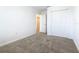 Bedroom featuring neutral carpet, closet with bi-fold doors, and white walls at 942 Jackson Ave, Davenport, FL 33837