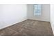 Clean and carpeted bedroom with a window allowing natural light at 942 Jackson Ave, Davenport, FL 33837