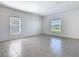 An empty bedroom features tiled floors, two windows, and neutral decor at 942 Jackson Ave, Davenport, FL 33837