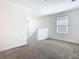Bright bonus room featuring plush carpet, a window, and neutral paint at 942 Jackson Ave, Davenport, FL 33837