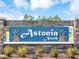 Entrance sign for community Astoria North with decorative stone pillars and lush landscaping at 942 Jackson Ave, Davenport, FL 33837