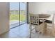 Bright dining area featuring a tile floor and sliding glass door to patio with backyard view at 942 Jackson Ave, Davenport, FL 33837