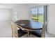 The dining area features a dark table, four chairs, and a sliding glass door to the yard at 942 Jackson Ave, Davenport, FL 33837