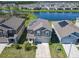 Two-story home featuring a lake view and solar panels, complemented by a well-manicured lawn at 942 Jackson Ave, Davenport, FL 33837