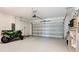 Large garage with an open door, shelving, motorcycle, and plenty of space for vehicles and storage at 942 Jackson Ave, Davenport, FL 33837