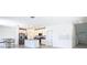 Open-concept kitchen and living area with stainless steel appliances and an island at 942 Jackson Ave, Davenport, FL 33837