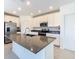 Bright kitchen features stainless appliances, island, and white cabinetry at 942 Jackson Ave, Davenport, FL 33837