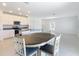 Open kitchen and dining area with stainless steel appliances and white cabinets at 942 Jackson Ave, Davenport, FL 33837