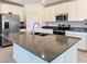 Modern kitchen showcasing a grey island, stainless steel appliances and a double sink at 942 Jackson Ave, Davenport, FL 33837