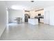 Bright, open-concept kitchen features stainless appliances, an island, and white cabinetry at 942 Jackson Ave, Davenport, FL 33837