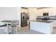 Modern kitchen island paired with stainless steel appliances, creating a culinary space at 942 Jackson Ave, Davenport, FL 33837