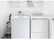 Well-lit laundry room featuring a washer and dryer, with a hanging rack above for drying clothes at 942 Jackson Ave, Davenport, FL 33837