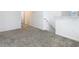 Living room with a carpeted floor and view of the staircase at 942 Jackson Ave, Davenport, FL 33837