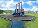 A modern playground with slides and other play equipment, surrounded by a grassy area at 942 Jackson Ave, Davenport, FL 33837