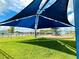 Shaded playground area in a community with lush green grass and views of neighborhood homes at 942 Jackson Ave, Davenport, FL 33837