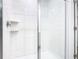 Walk-in shower featuring white tile and glass doors at 942 Jackson Ave, Davenport, FL 33837