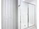 Bathroom featuring a tiled walk-in shower with sliding glass door, and a storage closet at 942 Jackson Ave, Davenport, FL 33837