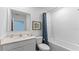 Clean bathroom with a white vanity, shower with tile, and a stylish framed artwork at 1028 Morfontaine St, Daytona Beach, FL 32124