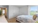 Comfortable bedroom with a view to the outdoors and doorway to hallway at 1028 Morfontaine St, Daytona Beach, FL 32124