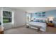 This primary bedroom has soothing blue tones, lots of natural light and a decorative bench at the foot of the bed at 1028 Morfontaine St, Daytona Beach, FL 32124