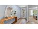 Stylish entryway with wood-look flooring, a modern mirror, a decorated table, and a glass door at 1028 Morfontaine St, Daytona Beach, FL 32124