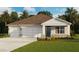 Charming one-story home featuring a three-car garage, stone accents, and a covered entryway at 1028 Morfontaine St, Daytona Beach, FL 32124