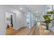 Hallway features wood-look flooring, light blue walls, and doorways to a bathroom and bedroom at 1028 Morfontaine St, Daytona Beach, FL 32124
