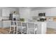 Well-lit kitchen with a center island with seating, stainless steel appliances, and white cabinetry at 1028 Morfontaine St, Daytona Beach, FL 32124