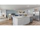 Modern kitchen with a large island, stainless steel appliances, and an open view to the living room at 1028 Morfontaine St, Daytona Beach, FL 32124