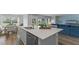 Bright open kitchen with a stainless steel dishwasher, kitchen island, and view to the dining room at 1028 Morfontaine St, Daytona Beach, FL 32124