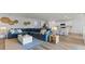 Spacious living room featuring a comfortable blue sectional, stylish decor, and an open concept to the kitchen at 1028 Morfontaine St, Daytona Beach, FL 32124