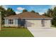Charming single-story home featuring a two-car garage and manicured lawn with tropical landscaping at 1040 Morfontaine St, Daytona Beach, FL 32124