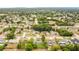 Wide aerial shot of a peaceful residential area featuring well-maintained homes, mature trees, and a community water tower at 1116 Adirondack St, Deltona, FL 32725