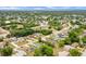 Expansive aerial view showcasing a tranquil neighborhood with lush greenery and diverse home styles under a clear sky at 1116 Adirondack St, Deltona, FL 32725