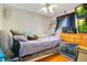Bedroom with ceiling fan, window and wooden dresser at 1116 Adirondack St, Deltona, FL 32725