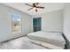 Simple bedroom with light gray walls, ceiling fan, a bed, light gray floors, and a closet at 1116 Adirondack St, Deltona, FL 32725