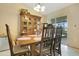 Traditional dining room setup featuring a dark wood table, matching china cabinet, and a sliding glass door at 1116 Adirondack St, Deltona, FL 32725