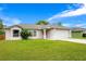 Inviting single-story home featuring a green lawn, neutral exterior paint, and an attached two-car garage at 1116 Adirondack St, Deltona, FL 32725