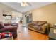 Comfortable living room with hardwood floors, neutral walls, and a view into the dining room and kitchen at 1116 Adirondack St, Deltona, FL 32725