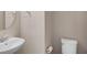 Powder room featuring a pedestal sink, modern fixtures, and a toilet at 11968 Sands Cv, Orlando, FL 32828