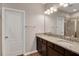 Bathroom featuring dual sinks, granite counters, and dark wood cabinets at 11968 Sands Cv, Orlando, FL 32828