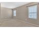 Spacious bedroom with neutral carpeting and two bright, windowed walls at 11968 Sands Cv, Orlando, FL 32828