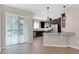 Open kitchen featuring dark wood cabinetry, stainless appliances, and granite breakfast bar at 11968 Sands Cv, Orlando, FL 32828