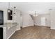Spacious living area with modern lighting, dark wood-look floors, and convenient breakfast bar at 11968 Sands Cv, Orlando, FL 32828