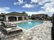 Community pool with lounge seating and a covered pavilion, perfect for relaxation and socializing at 11968 Sands Cv, Orlando, FL 32828