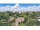 Stunning aerial shot of home with lush greenery and a glimpse of the lake in the background at 123 Tangelo Court, Maitland, FL 32751